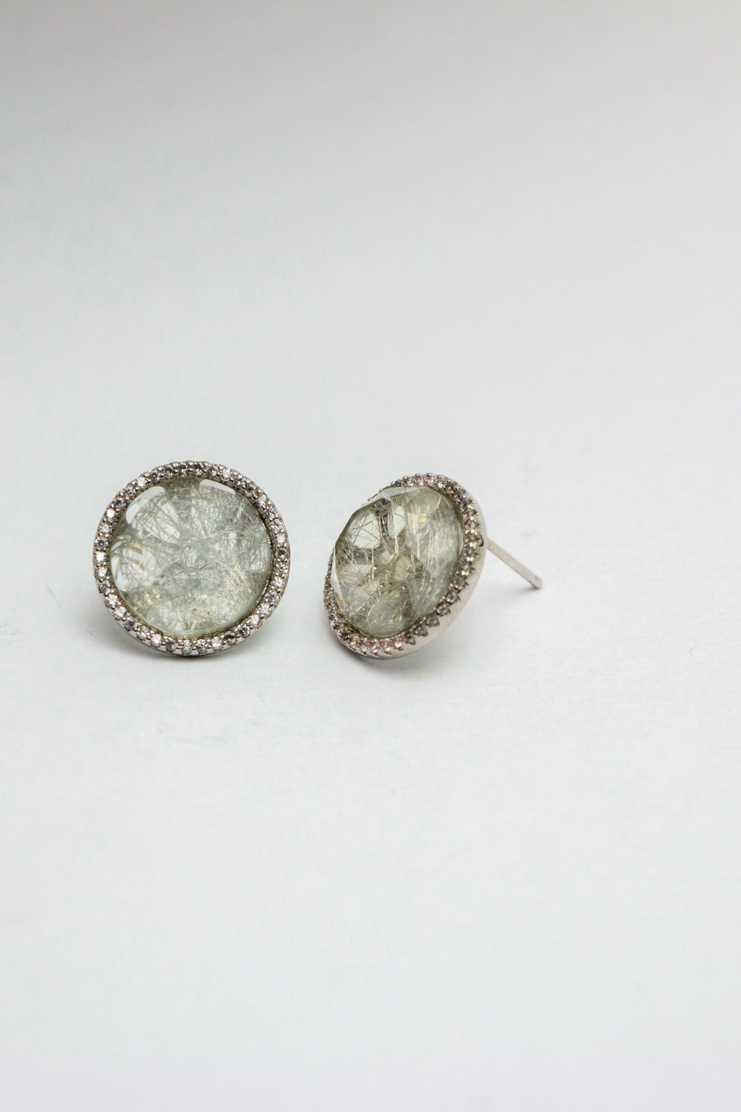 Quartz earrings facing forward on white surface