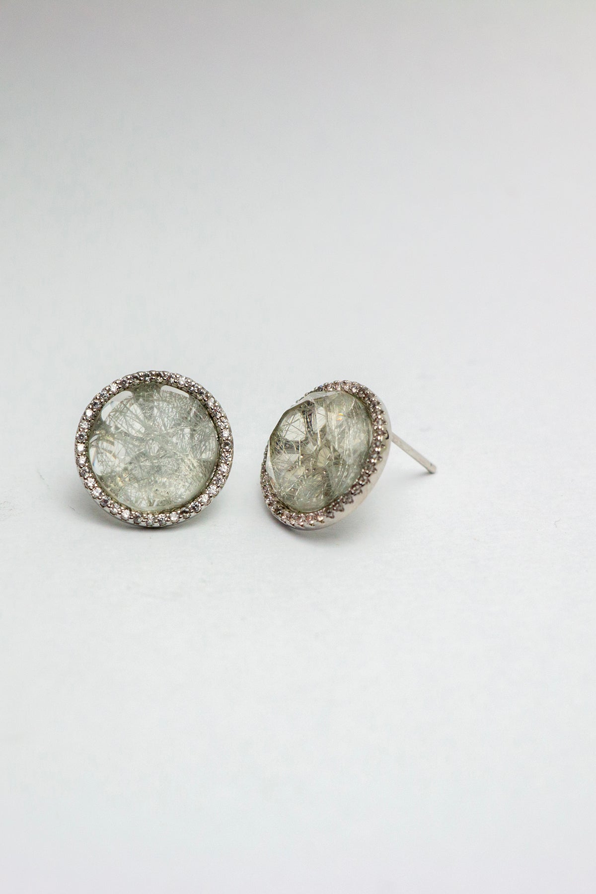 Quartz earrings facing forward on white surface