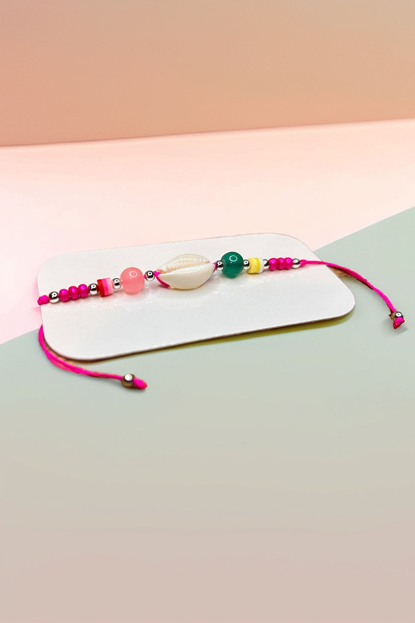 Side angle of multicolored beaded bracelet with shell