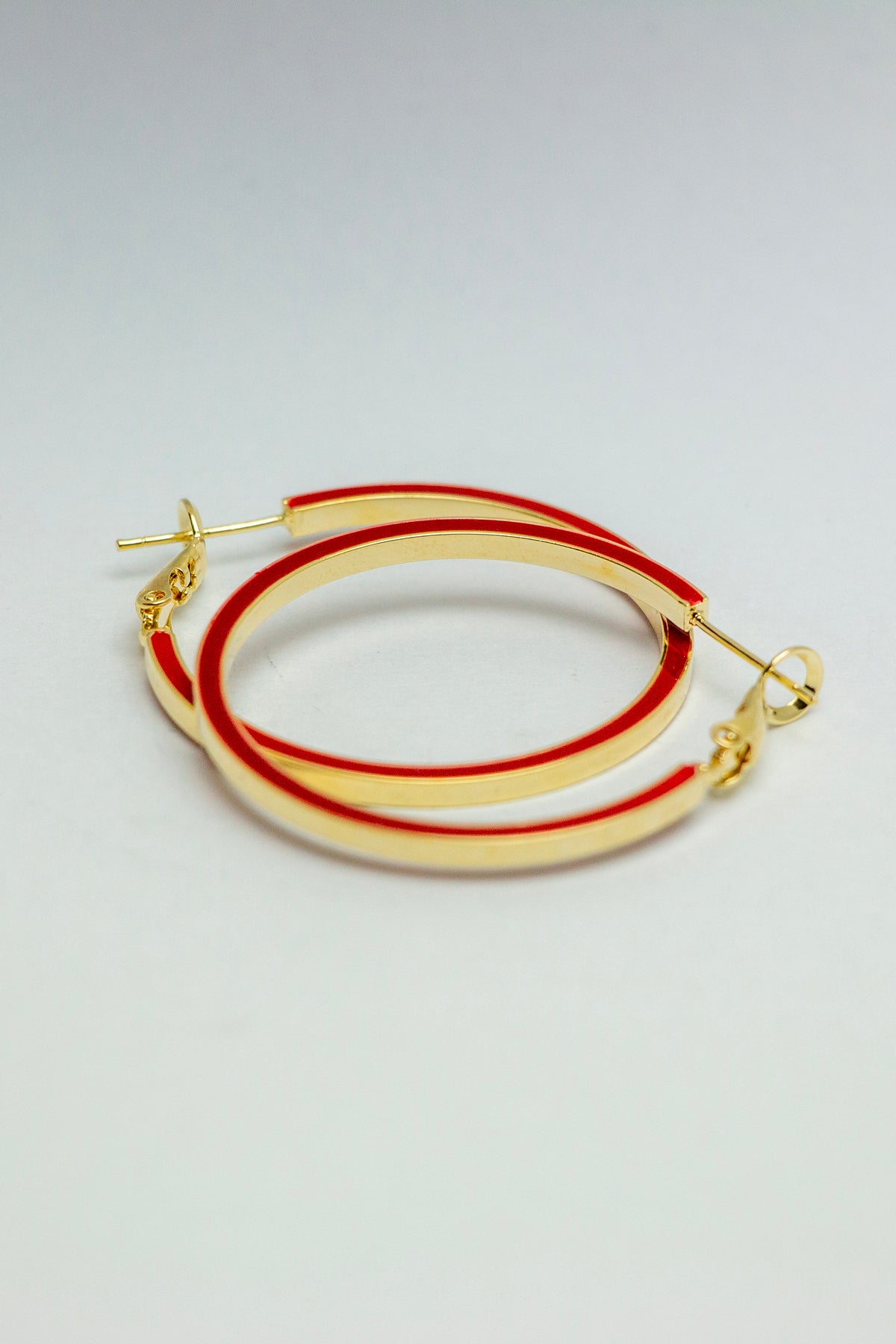 Side angle view of gold-tone hoop earrings
