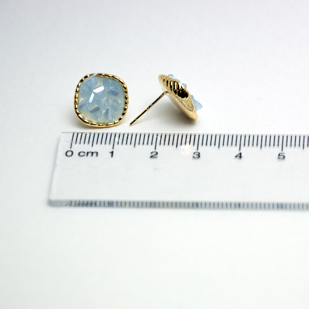 Opal earrings with ruler indicating size