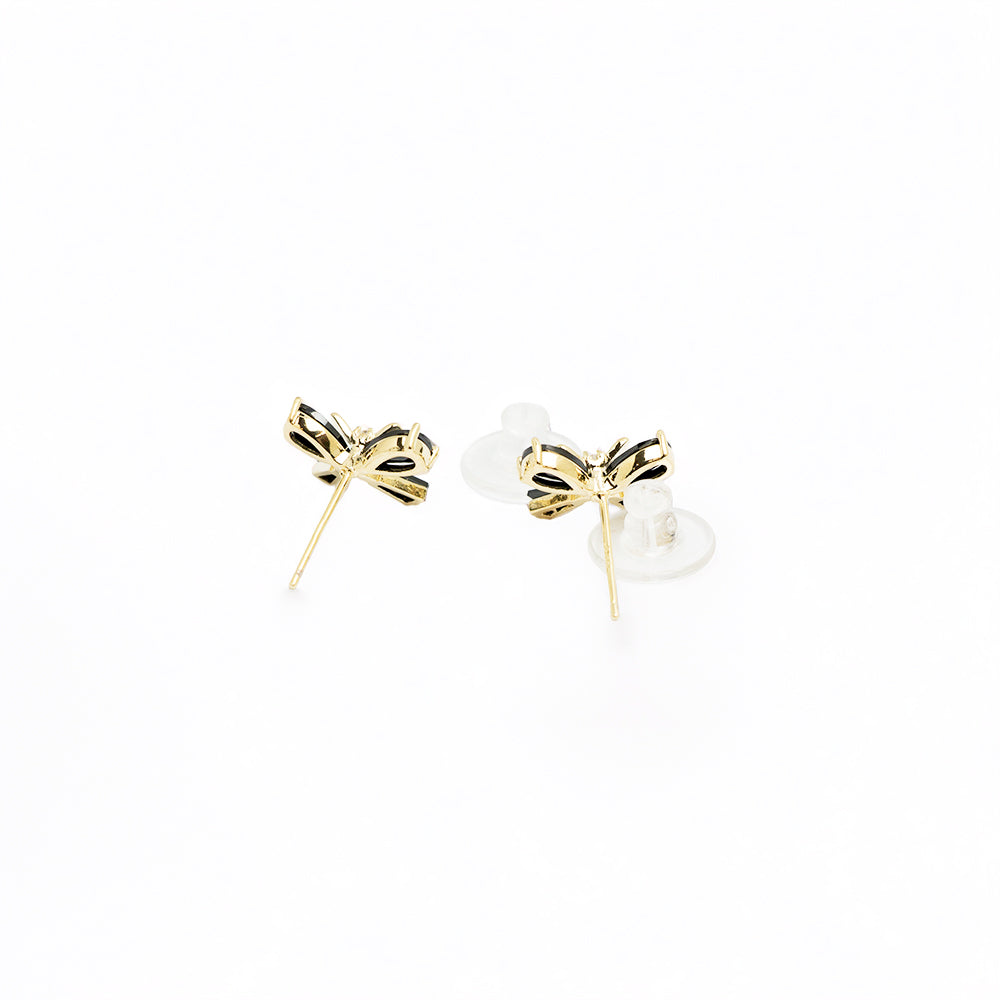 Black bow earrings from the side on white background