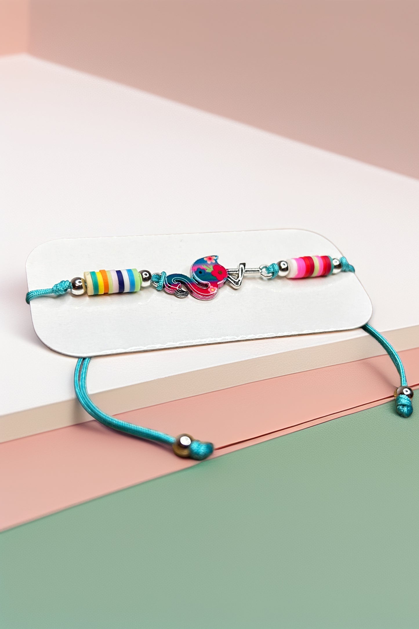 Side angle of colorful bracelet on pastel surface