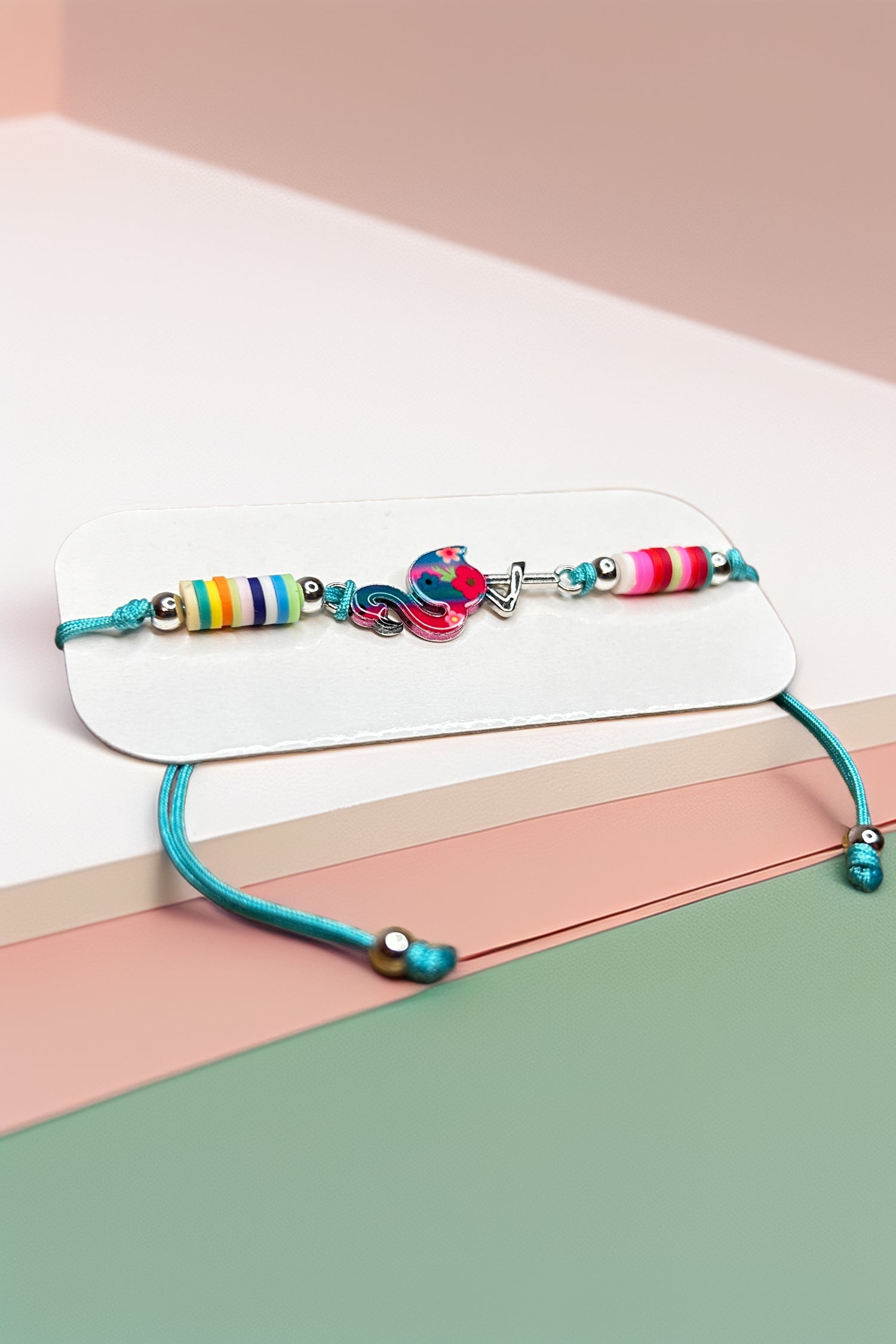 Side angle of colorful bracelet on pastel surface