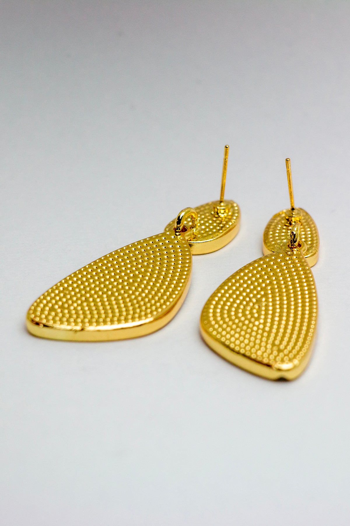 Back view of gold dangle earrings with posts