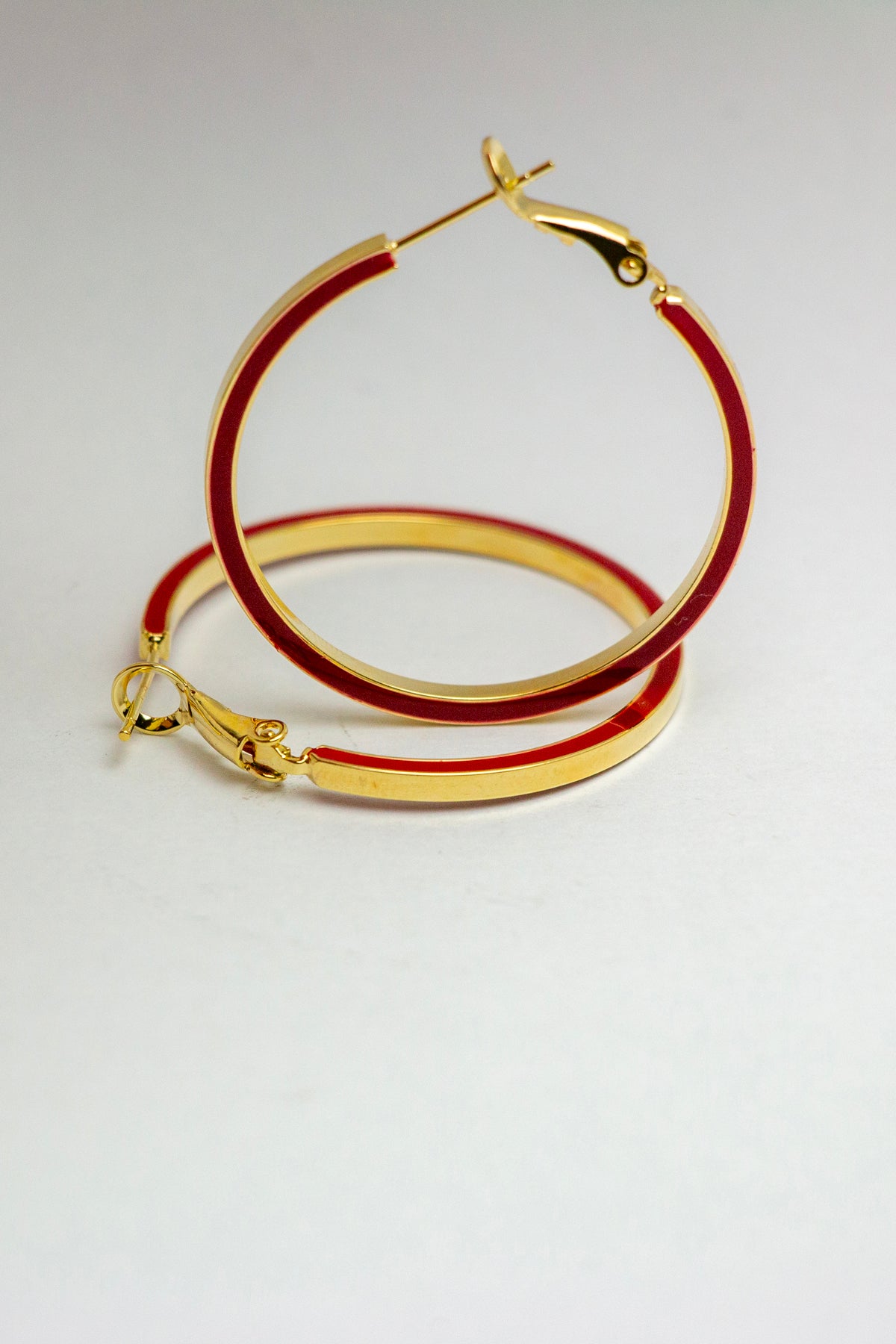 Earrings showing width and red enamel detail