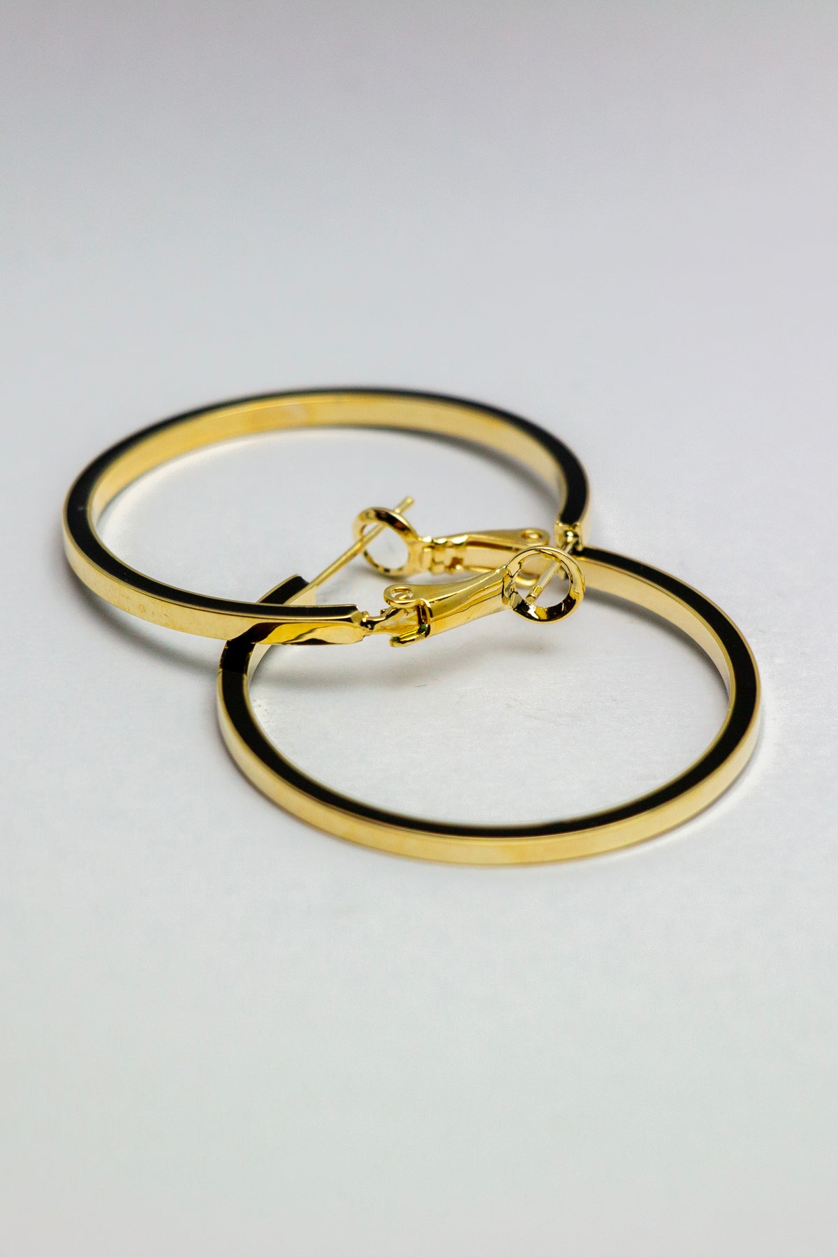 Gold hoop earrings with secured clasp