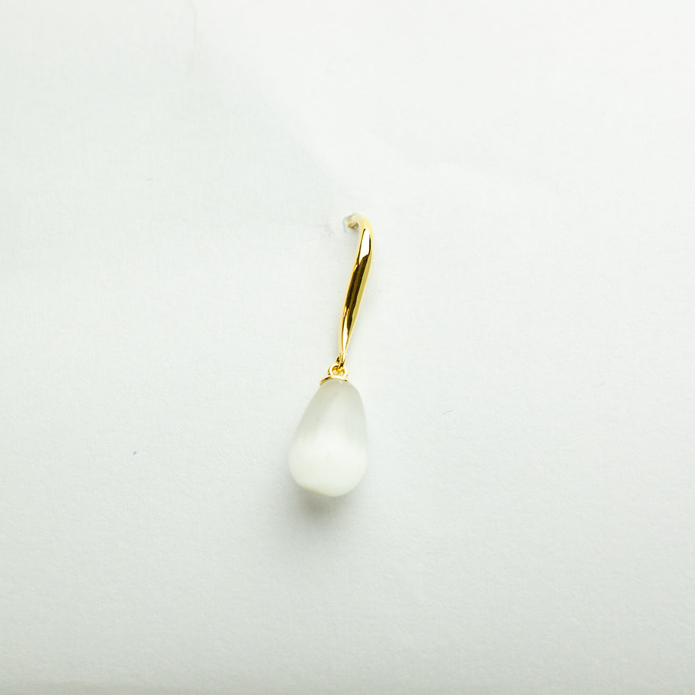 Single gold and pearl teardrop earring close-up