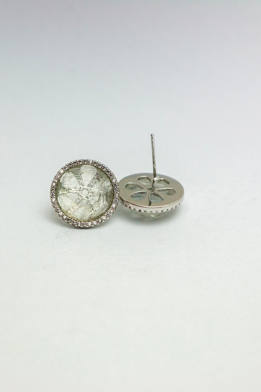 Side angle of quartz earrings with one tilted