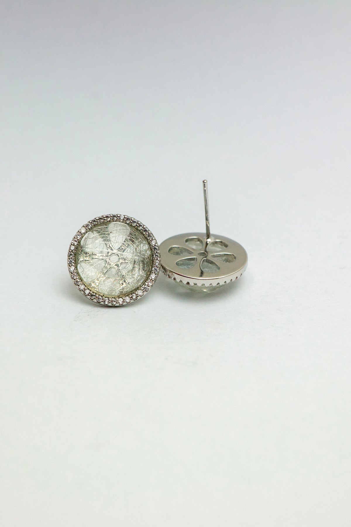 Side angle of quartz earrings with one tilted